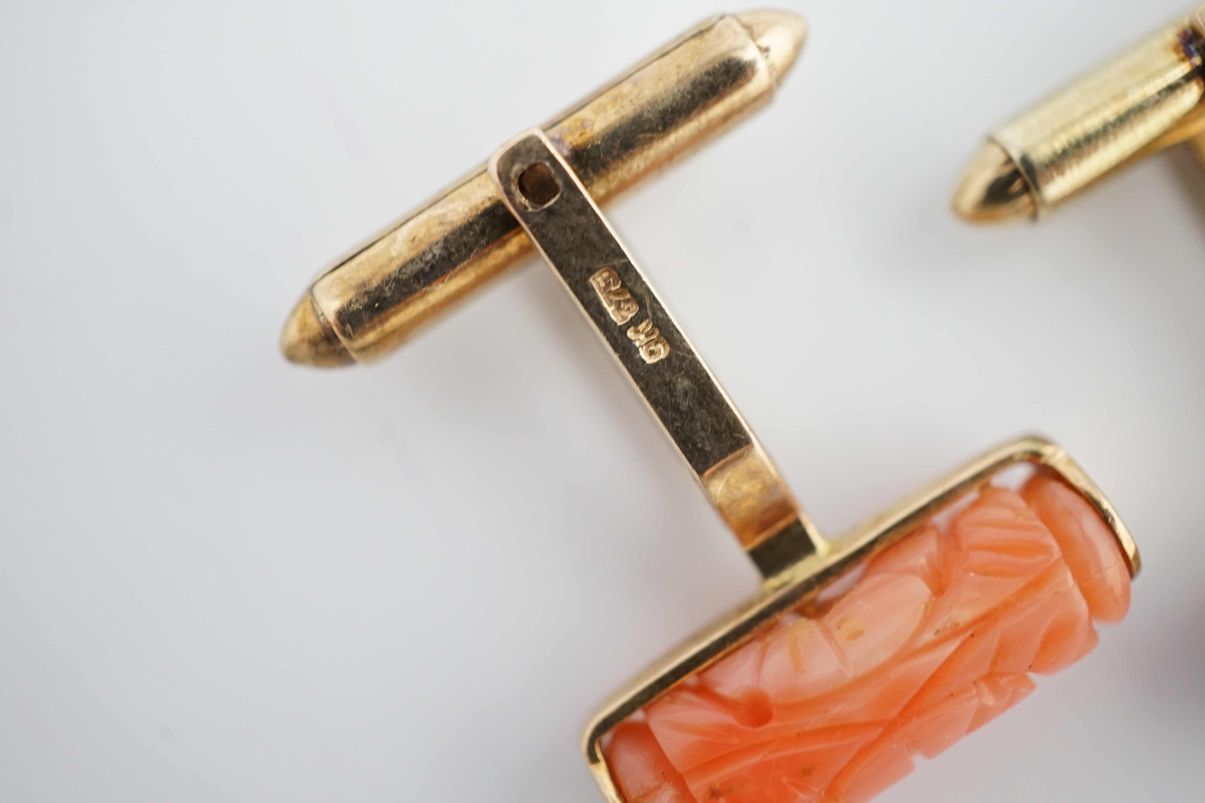 A pair of 9k gold and carved coral set cufflinks